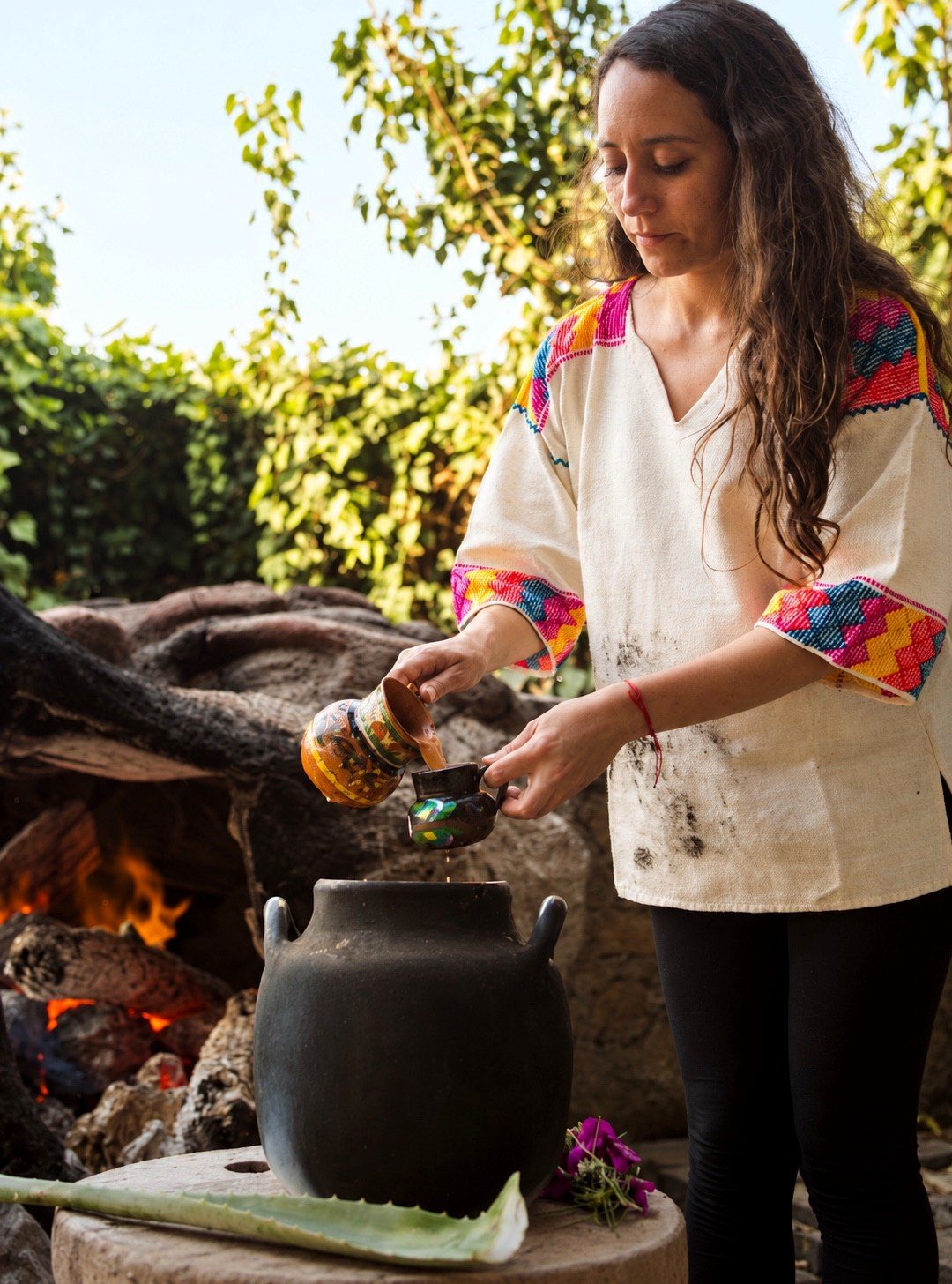 Eréndira helping serve cacao at Aldea Tonantzin